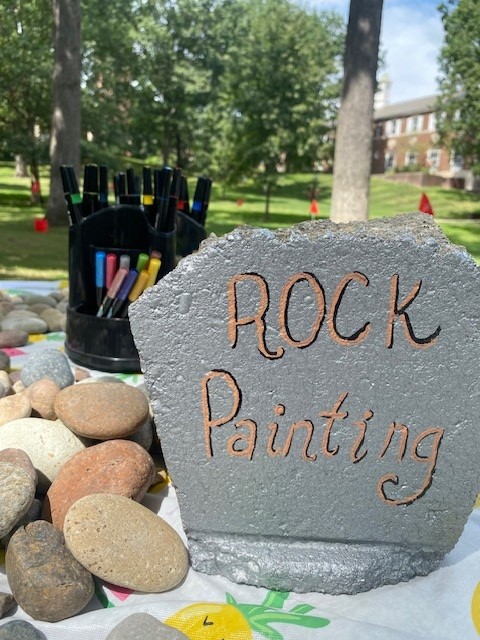 A painted stone that says rock painting