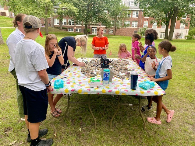 various people painting rocks